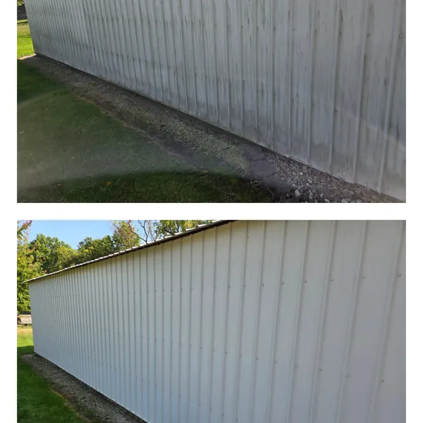 Before and after soft washing along the full length of a white pole barn wall